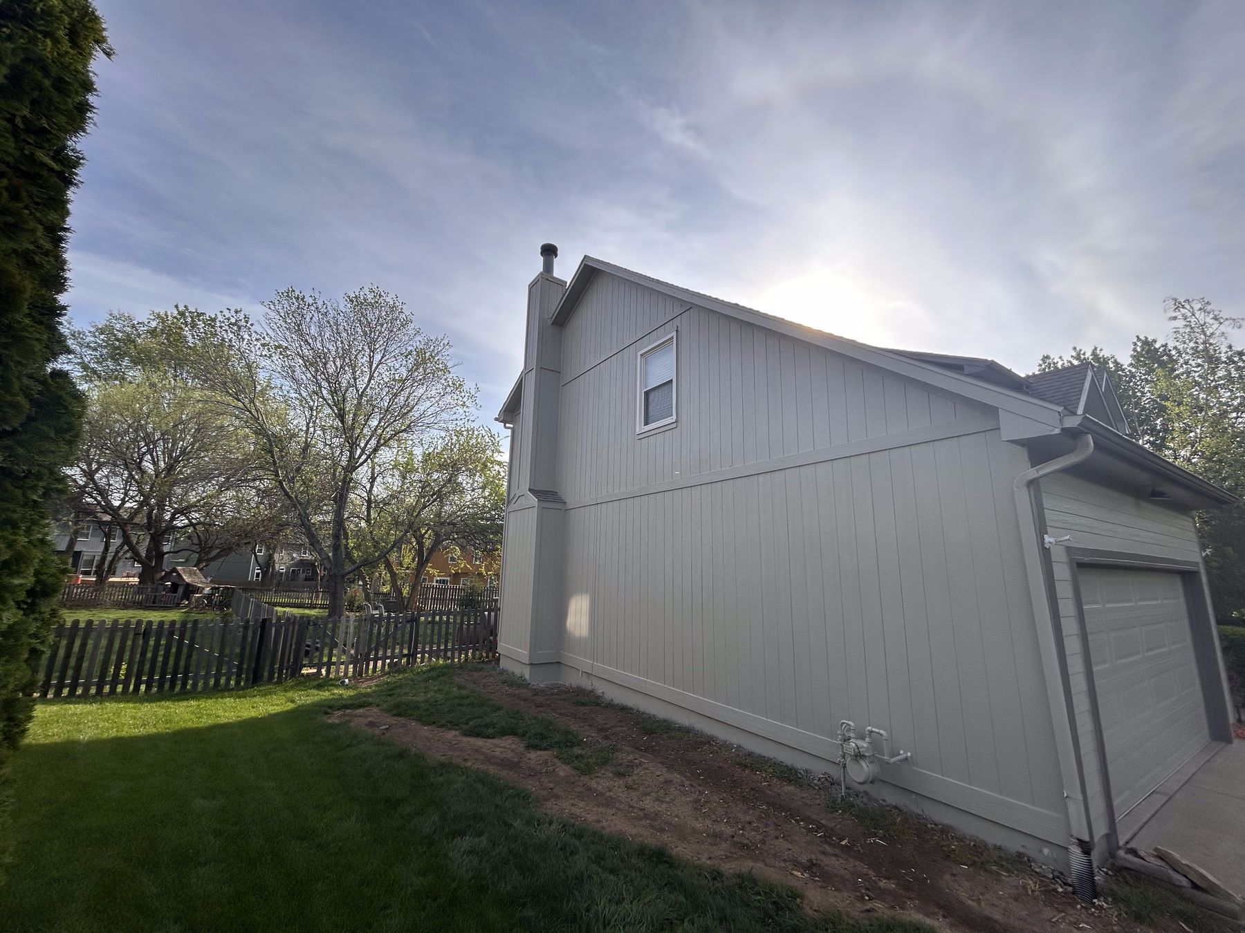 Same wall after siding replacement and painting โ seamless finished exterior by EverPro Painting